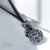 FEKETE BŐR NYAKLÁNC FEKETE ÉS FEHÉR SWAROVSKI KÖVES GÖMB MEDÁLLAL